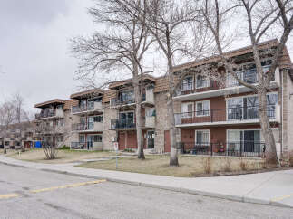 Discover comfortable living in this multi-story apartment building, featuring balconies on each unit and ample natural light.