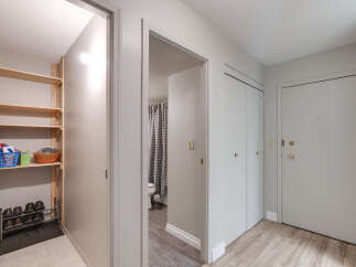 Discover practical storage solutions in this home, featuring a dedicated shoe rack and shelving unit perfect for organizing essentials.