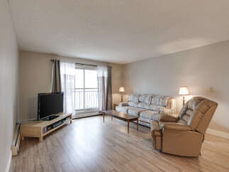Step into this inviting living room, featuring a comfortable sofa and a plush recliner perfect for relaxation.