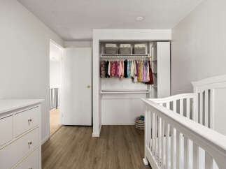 This charming nursery features a white crib and a matching dresser, perfect for a new arrival.