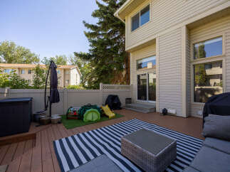 Enjoy outdoor living on this spacious wooden deck, perfect for entertaining or relaxing.