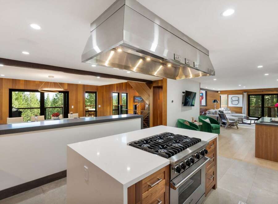 Experience luxury mountain living in this stunning home featuring a gourmet kitchen with a professional-grade gas range and expansive island.