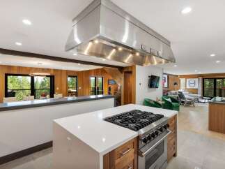 Experience luxury mountain living in this stunning home featuring a gourmet kitchen with a professional-grade gas range and expansive island.
