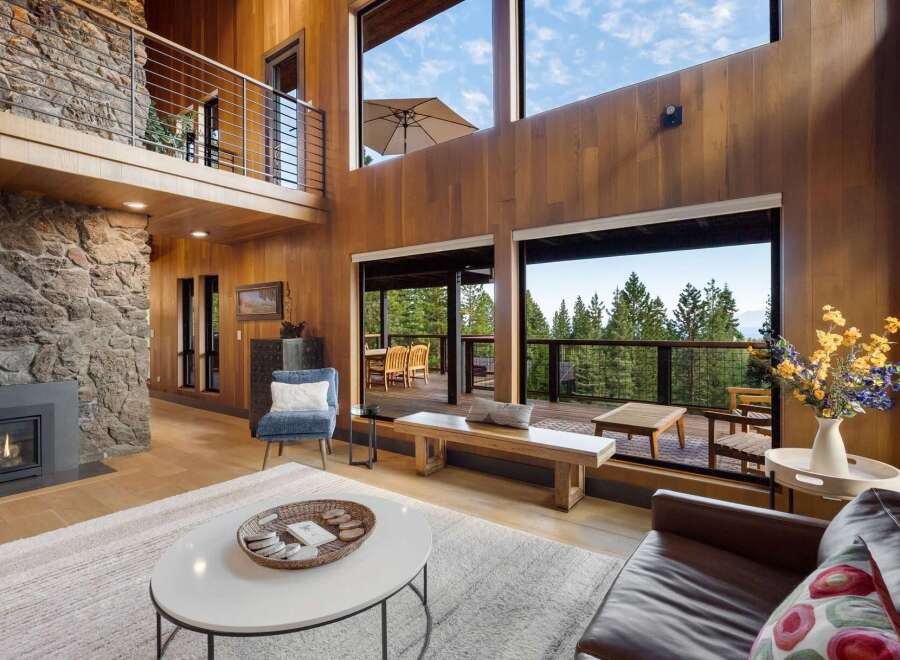Experience breathtaking mountain views from this stunning contemporary home, featuring expansive windows and a spacious open-concept living area.