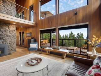 Experience breathtaking mountain views from this stunning contemporary home, featuring expansive windows and a spacious open-concept living area.