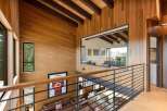 Experience modern luxury in this stunning home featuring warm wood paneling and exposed beams throughout.