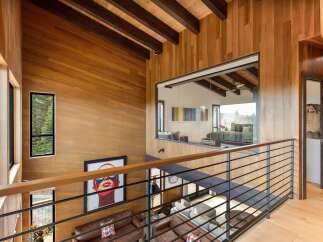 Experience modern luxury in this stunning home featuring warm wood paneling and exposed beams throughout.