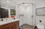 Experience modern luxury in this stunning bathroom featuring a spacious glass-enclosed shower with sleek tilework and a hexagonal floor.