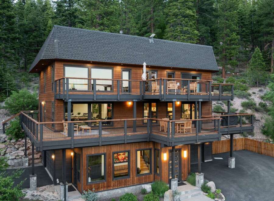 Experience luxury mountain living in this stunning multi-level home, nestled amidst a serene forest.