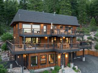 Experience luxury mountain living in this stunning multi-level home, nestled amidst a serene forest.