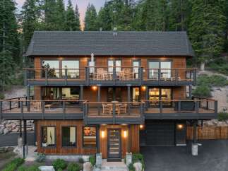 Experience luxury mountain living in this stunning multi-level home, nestled amidst a serene forest landscape.