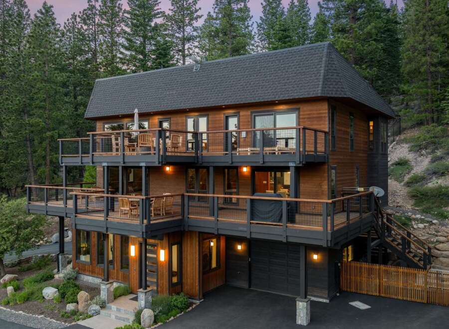 Experience luxury mountain living in this stunning multi-level home, featuring expansive decks with breathtaking forest views.