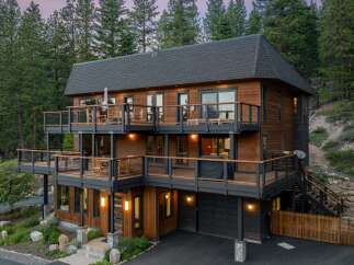 Experience luxury mountain living in this stunning multi-level home, featuring expansive decks with breathtaking forest views.