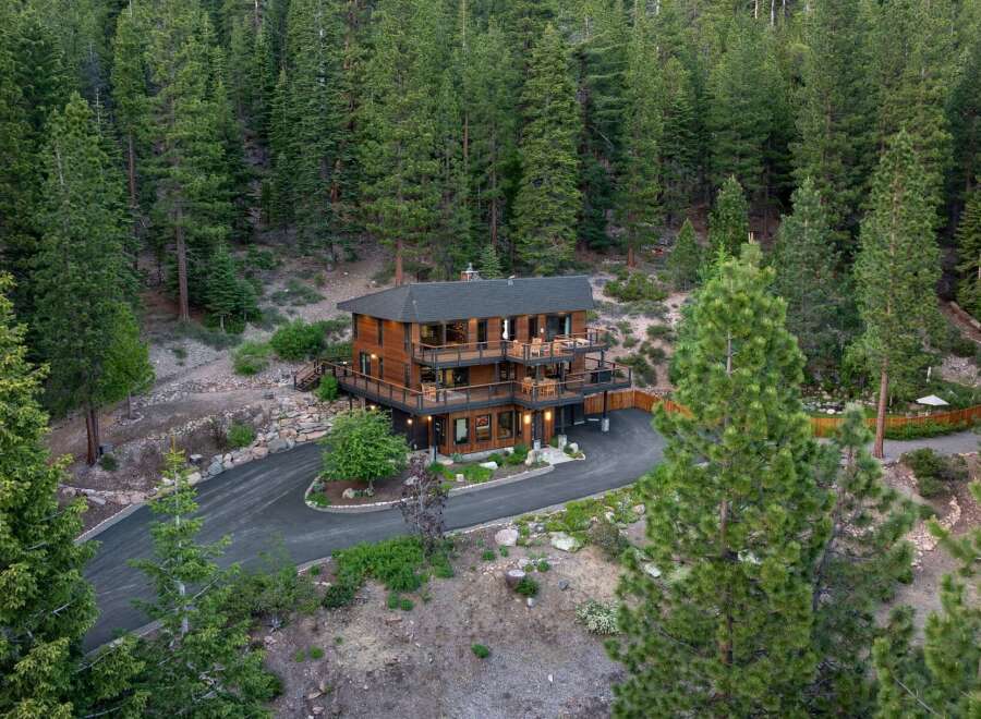 Nestled amidst a dense forest, this stunning multi-level wooden home offers a serene retreat.