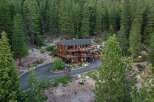 Nestled amidst a dense forest, this stunning multi-level wooden home offers a serene retreat.