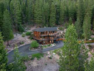 Nestled amidst a dense forest, this stunning multi-level wooden home offers a serene retreat.