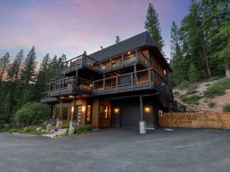 Experience luxury mountain living in this stunning multi-level home nestled among tall pine trees.