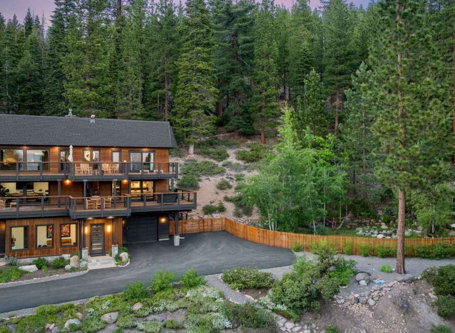 Nestled amidst a lush forest, this stunning multi-level home offers breathtaking views and ample outdoor living space.