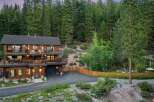 Nestled amidst a lush forest, this stunning multi-level home offers breathtaking views and ample outdoor living space.