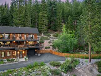 Nestled amidst a lush forest, this stunning multi-level home offers breathtaking views and ample outdoor living space.