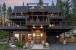 Experience modern mountain living in this stunning multi-level home, featuring expansive decks perfect for enjoying the surrounding forest views.