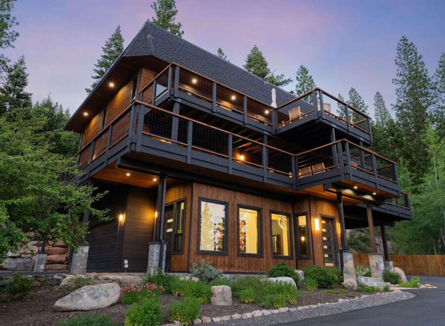 Experience luxury mountain living in this stunning multi-level home, featuring expansive decks perfect for enjoying the serene forest views.