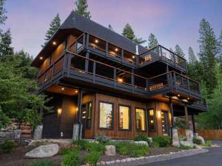 Experience luxury mountain living in this stunning multi-level home, featuring expansive decks perfect for enjoying the serene forest views.