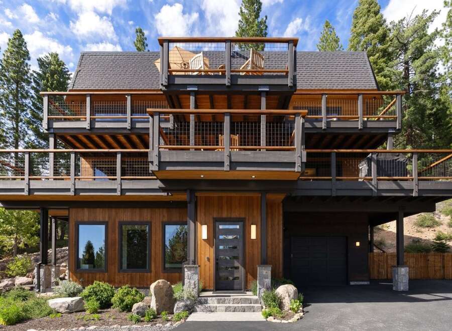 Experience modern mountain living in this stunning multi-level home, featuring expansive decks with breathtaking views and a sleek, contemporary design.