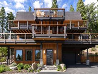 Experience modern mountain living in this stunning multi-level home, featuring expansive decks with breathtaking views and a sleek, contemporary design.