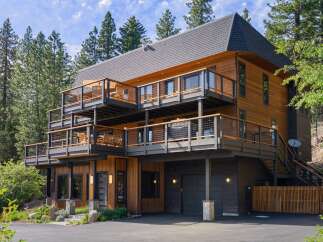 Experience luxury mountain living in this stunning multi-level home, nestled amidst towering pine trees.