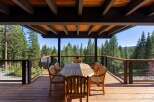 Enjoy breathtaking forest views from this expansive wooden deck, perfect for outdoor dining and entertaining.