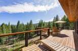 Enjoy breathtaking forest views from this expansive wooden deck, perfect for outdoor living and entertaining.