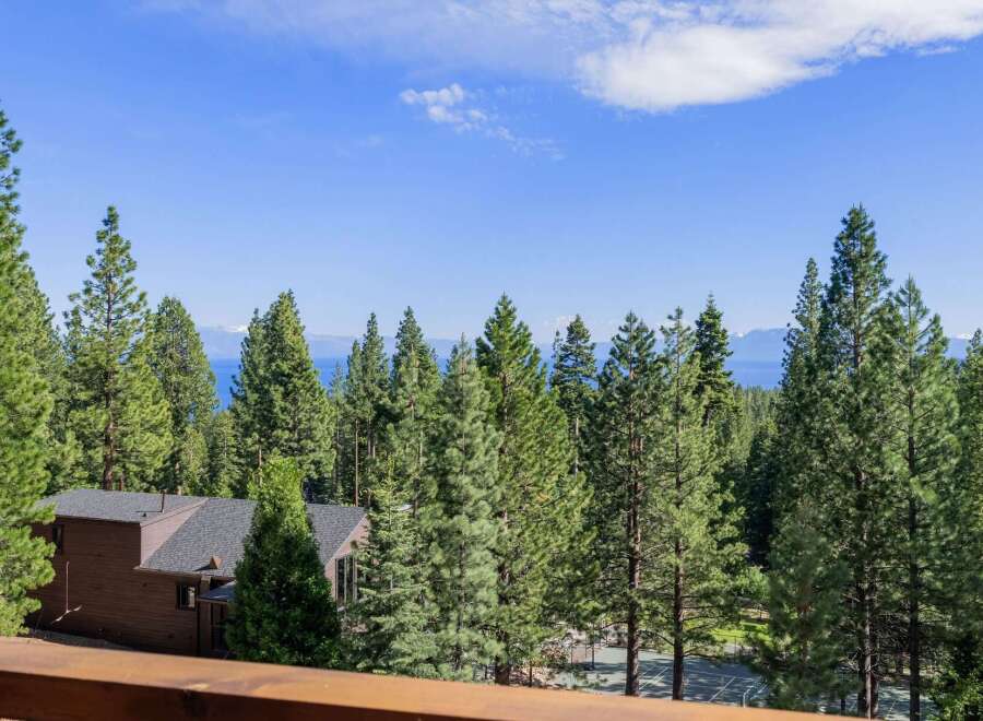 Experience breathtaking lake and mountain views from this stunning property nestled among tall pine trees.