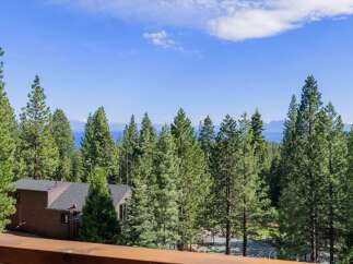 Experience breathtaking lake and mountain views from this stunning property nestled among tall pine trees.
