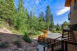 Discover this stunning mountain retreat featuring a modern wooden exterior and expansive decks perfect for enjoying the serene forest views.