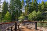 Enjoy the serene mountain views from this beautiful deck, surrounded by lush pine trees.