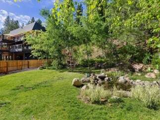 Experience luxury living in this stunning multi-level home, featuring expansive decks perfect for enjoying the surrounding natural beauty.