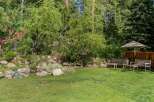 Enjoy the serene backyard oasis featuring a charming water feature and lush greenery, perfect for relaxation.