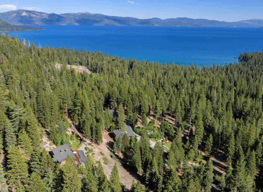 Experience breathtaking lake views from this stunning property nestled amongst towering pine trees.