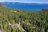 Experience breathtaking lake views from this stunning property nestled amongst towering pine trees.