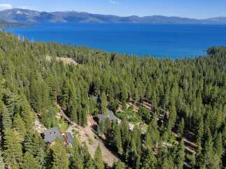 Experience breathtaking lake views from this stunning property nestled amongst towering pine trees.