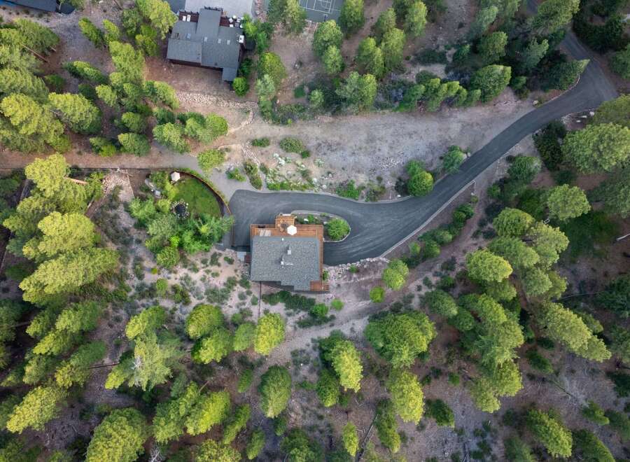 Discover this stunning property nestled amidst a lush pine forest, offering unparalleled privacy and natural beauty.
