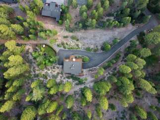 Discover this stunning property nestled amidst a lush pine forest, offering unparalleled privacy and natural beauty.