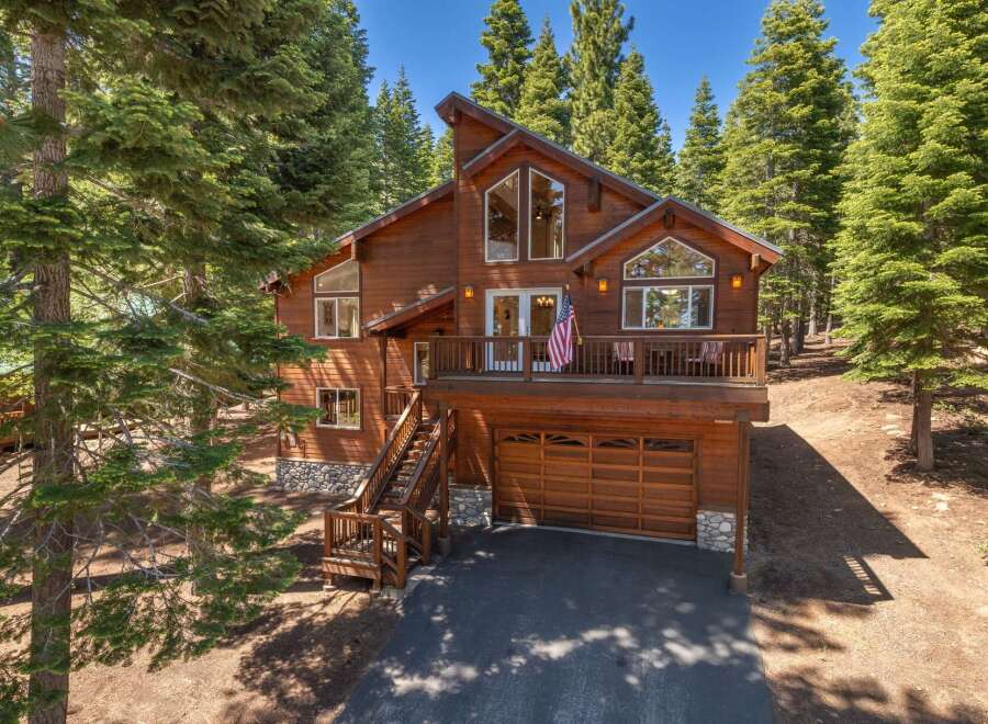 Nestled amidst towering pine trees, this stunning wooden mountain home offers a serene escape.