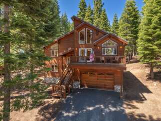 Nestled amidst towering pine trees, this stunning wooden mountain home offers a serene escape.