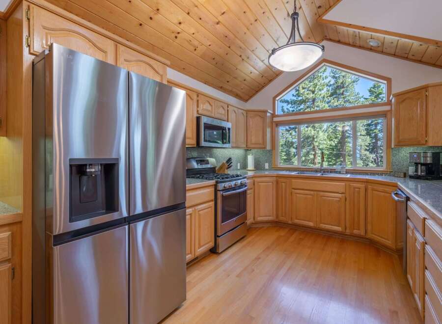 Experience breathtaking mountain views from this stunning kitchen, featuring a large picture window that floods the space with natural light.