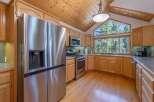 Experience breathtaking mountain views from this stunning kitchen, featuring a large picture window that floods the space with natural light.