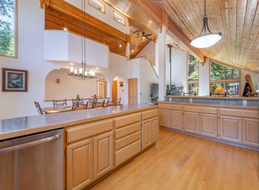 Experience rustic charm in this spacious kitchen featuring vaulted wood-beamed ceilings and a large island perfect for entertaining.