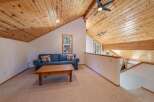 Experience rustic charm in this cozy living space featuring a comfortable blue sofa adorned with decorative pillows and a sturdy wooden coffee table.
