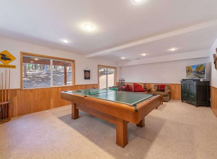 Enjoy endless entertainment in this finished basement, featuring a full-size pool table perfect for game nights.